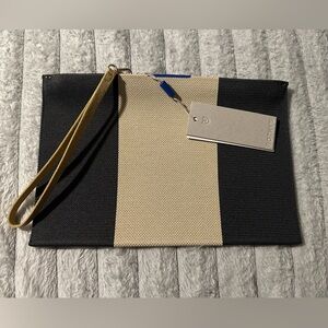 Rothy's The Essential Pouch (or The Wristlet) in Ink and Ivory.